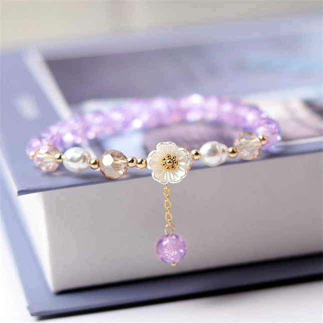 Bracelet élégant en perles violettes et fleurs blanches