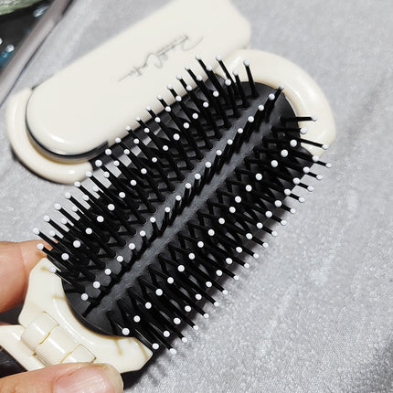 Brosse à cheveux pliable et portable avec miroir