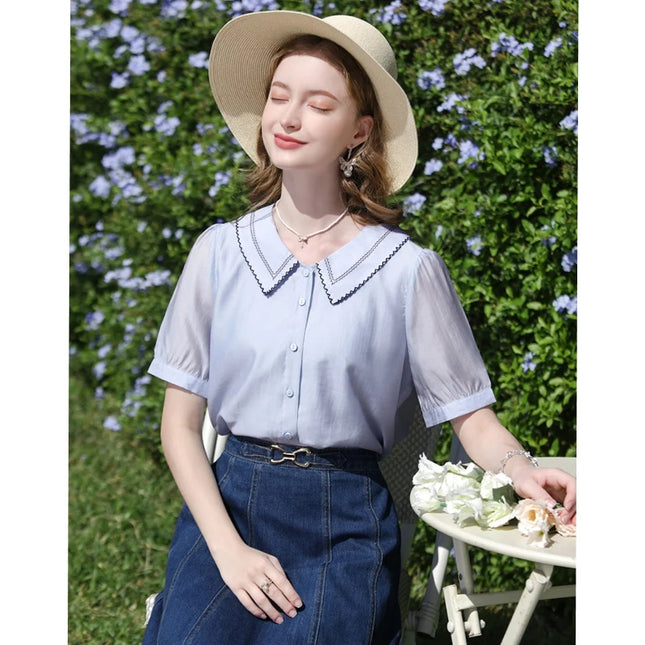 Blusa de mujer con mangas abullonadas y bordado francés