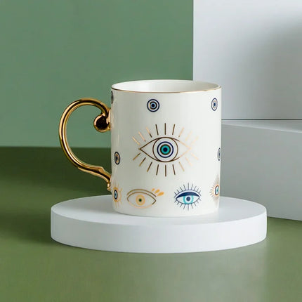 Taza de café de cerámica de lujo con forma de ojo de diablo bañada en oro